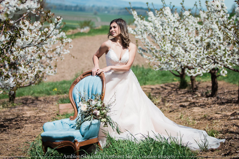 Perryhill Farm Wedding Bride with floral blossoms in orchard with blue vintage chair