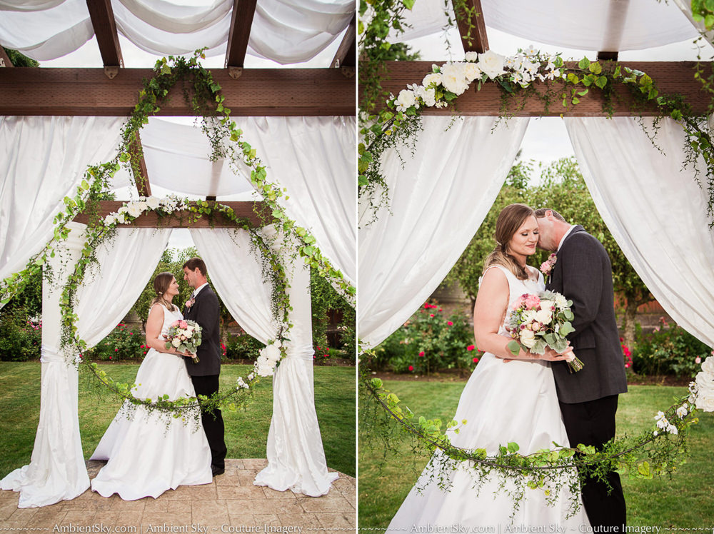 Wedding Arbor at the water oasis with bride and groom kissing